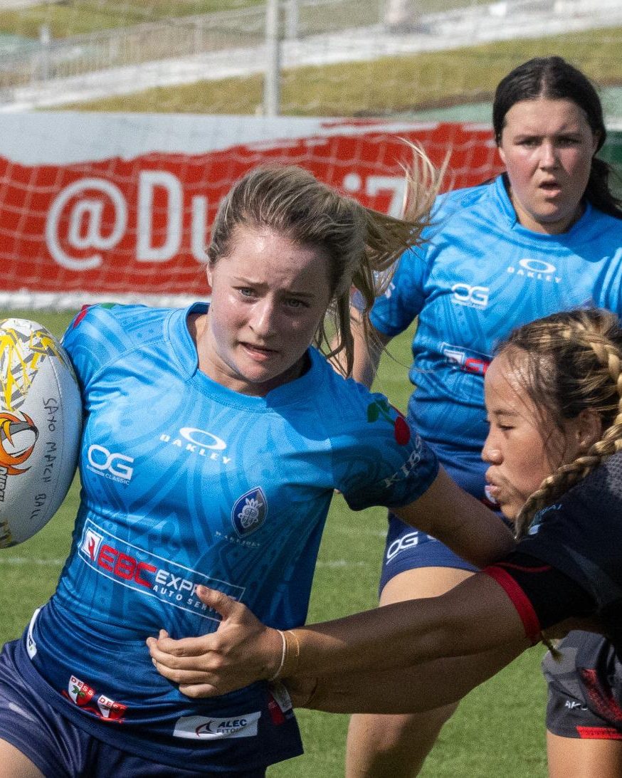 A Dubai Warriors junior carrying the ball in a rugby match